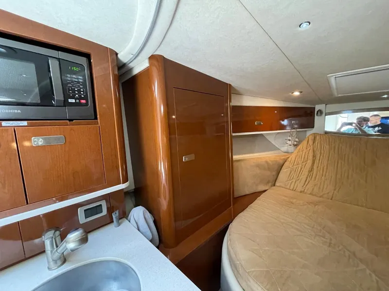 Slide: The Image of Interior of 2010 Sea Ray 350 Sundancer with kitchenette and cozy sleeping area. - 35