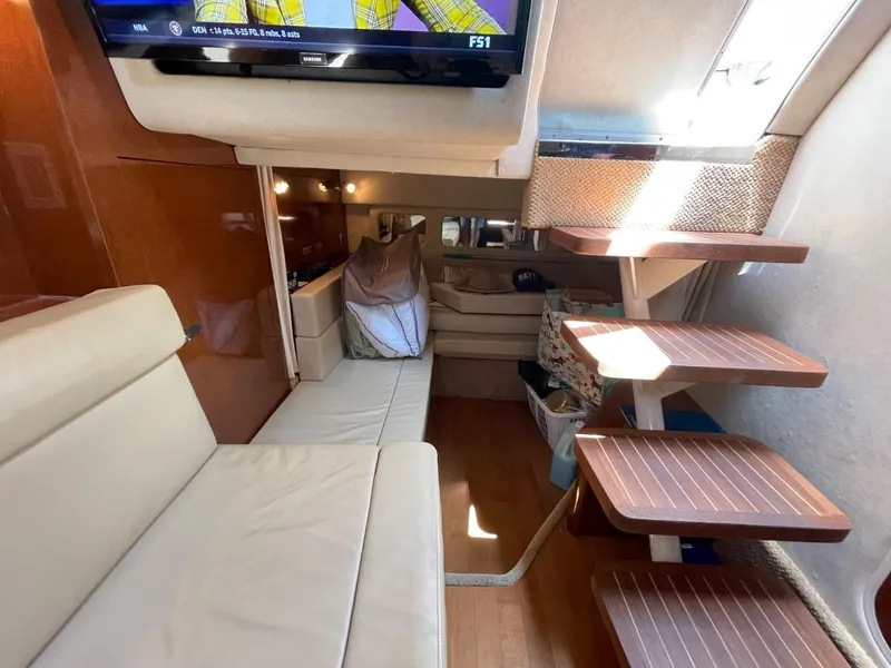 Slide: The Image of Interior of 2010 Sea Ray 350 Sundancer yacht with modern seating and wooden steps. - 43