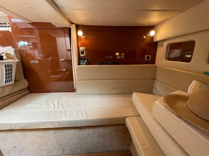Slide: The Image of Interior of 2010 Sea Ray 350 Sundancer yacht with beige seating and wooden accents. - 47