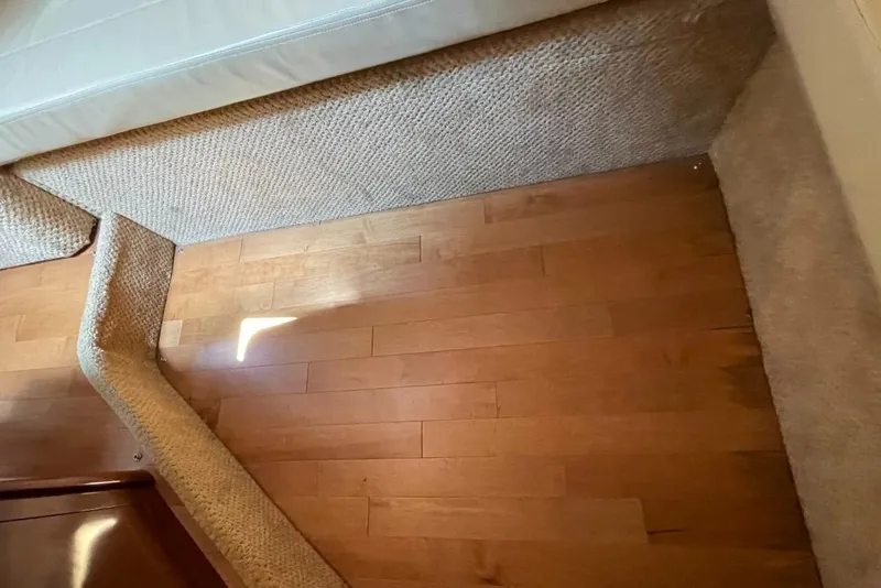 Slide: The Image of Interior view of 2010 Sea Ray 350 Sundancer with wooden flooring and carpeted steps. - 49