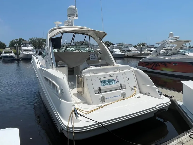 Slide: The Image of 2010 Sea Ray 350 Sundancer docked at marina, rear view. - 9