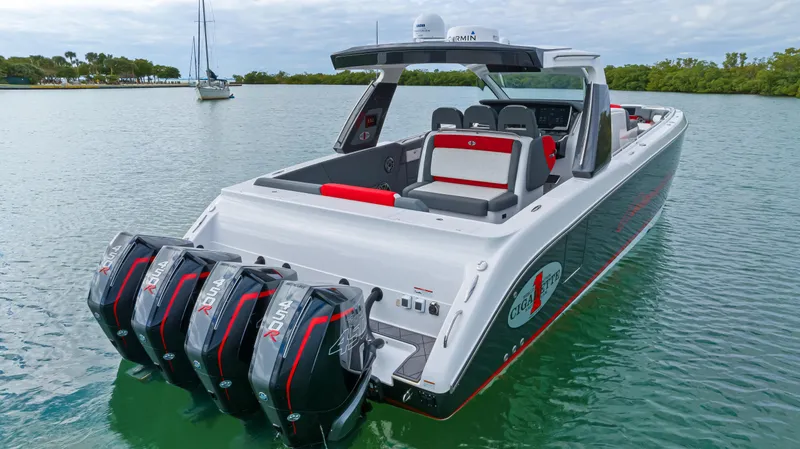 Slide: The Image of 2022 Cigarette 42 Auroris boat with triple outboard engines on a calm lake. - 10