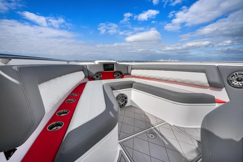 Slide: The Image of 2022 Cigarette 42 Auroris boat interior with modern seating and cup holders under a blue sky. - 13