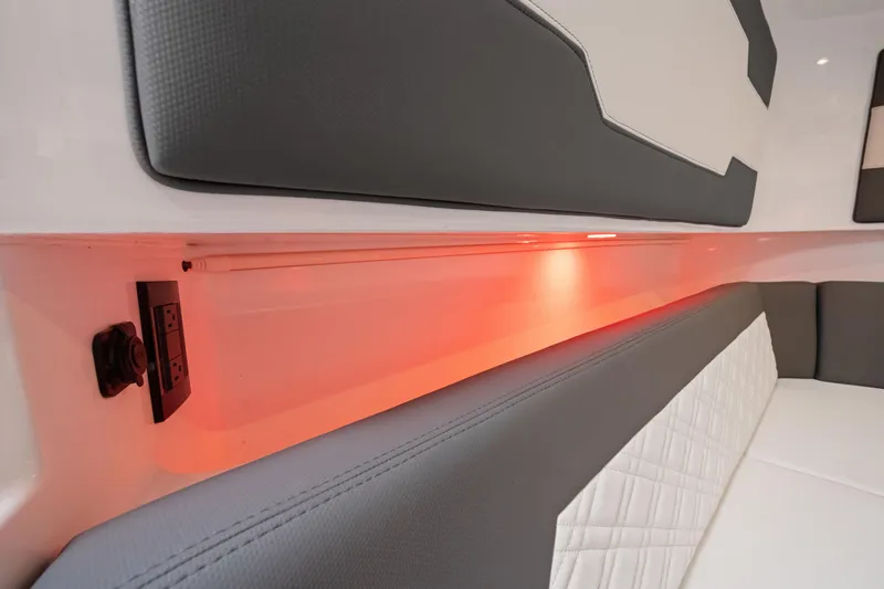 Slide: The Image of 2022 Cigarette 42 Auroris interior with ambient red lighting and cushioned seating. - 34