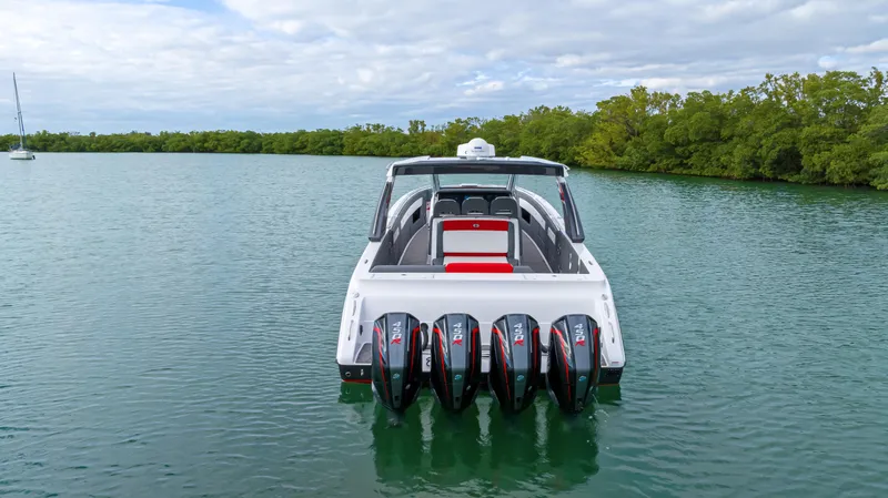 Slide: The Image of 2022 Cigarette 42 Auroris boat with five engines on a serene lake. - 9