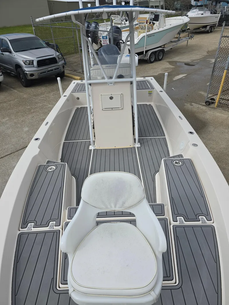 Slide: The Image of 2006 Pathfinder 2400 TRS boat with seating and console, docked in a marina. - 12