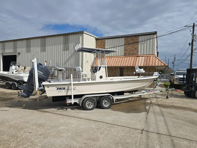 Slide: The Image of 2006 Pathfinder 2400 TRS boat on trailer outside a warehouse. - 3