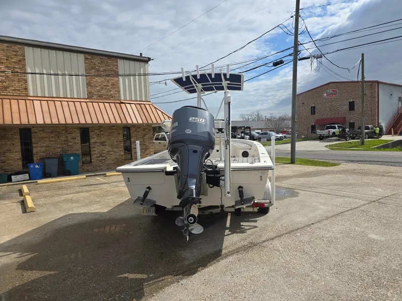 Slide: The Image of 2006 Pathfinder 2400 TRS boat with Yamaha engine parked outside a building. - 4