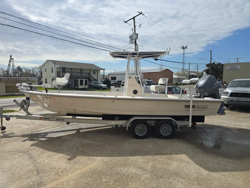 Slide: The Image of 2006 Pathfinder 2400 TRS boat on trailer in parking lot, overcast sky. - 6