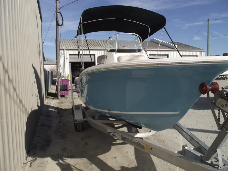 Slide: The Image of 2016 Sea Fox 186 Commander boat on trailer with blue hull and black canopy. - 2