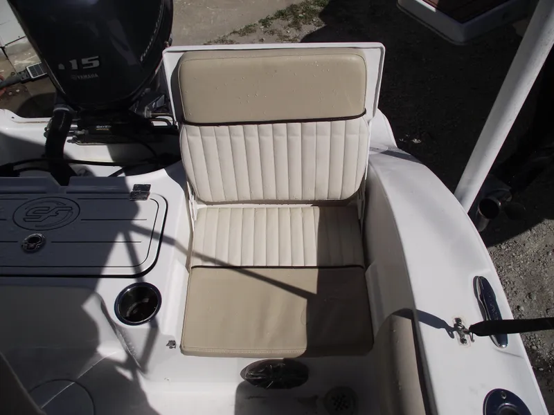 Slide: The Image of 2016 Sea Fox 186 Commander boat seat with beige upholstery and motor in background. - 29