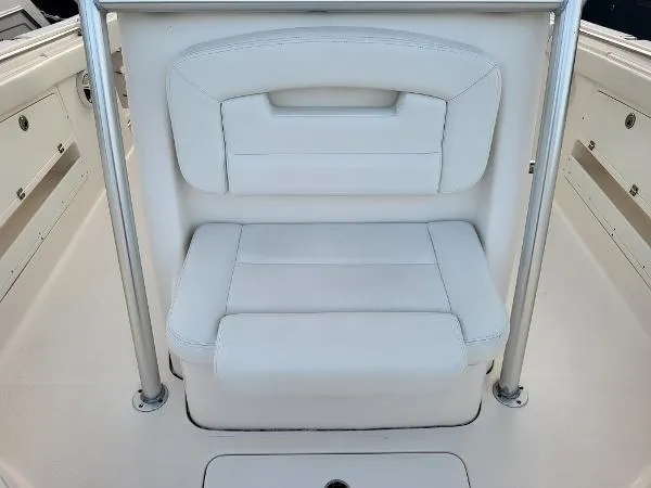 Slide: The Image of White cushioned seat on 2014 Robalo R 300 boat, featuring sleek design and sturdy metal frame. - 10