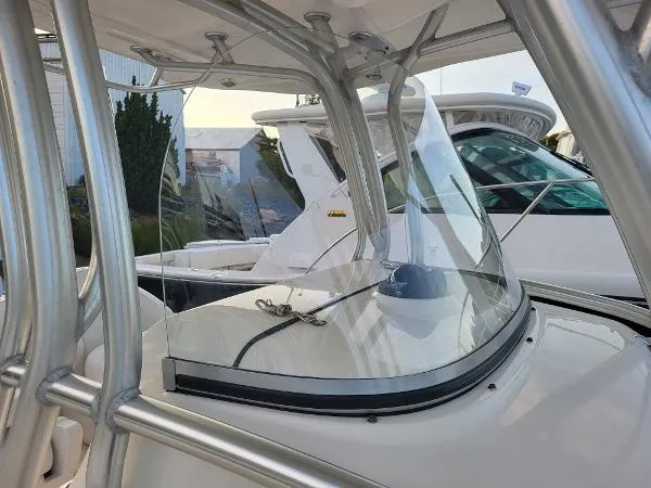 Slide: The Image of 2014 Robalo R 300 boat with sleek windshield and sturdy frame. - 15