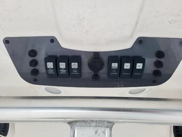 Slide: The Image of Control panel of a 2014 Robalo R 300 boat with various switches. - 16