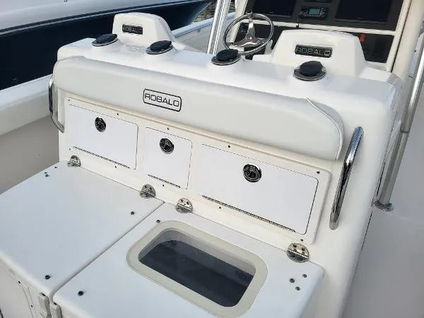 Slide: The Image of 2014 Robalo R 300 boat console with storage compartments and steering wheel. - 18