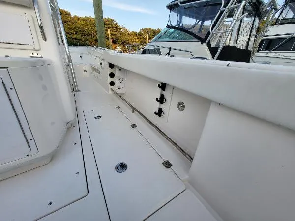 Slide: The Image of 2014 Robalo R 300 boat deck with storage compartments and clean white finish. - 19