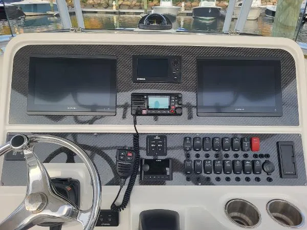Slide: The Image of Control panel of a 2014 Robalo R 300 boat with dual Garmin displays. - 22