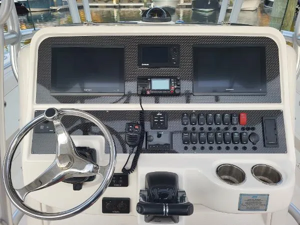 Slide: The Image of Control panel of 2014 Robalo R 300 boat with steering wheel and electronic displays. - 26