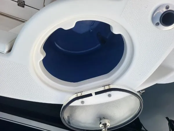 Slide: The Image of 2014 Robalo R 300 boat compartment with open circular hatch. - 31