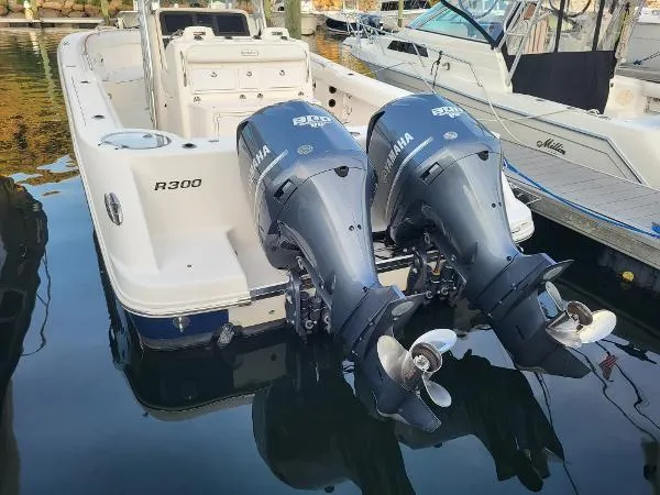 Slide: The Image of 2014 Robalo R300 boat with twin Yamaha outboard engines docked in marina. - 32