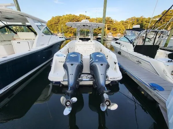 Slide: The Image of 2014 Robalo R 300 boat docked with twin outboard engines. - 33
