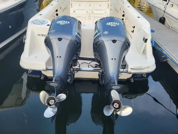 Slide: The Image of 2014 Robalo R 300 boat with twin outboard engines docked in water. - 35