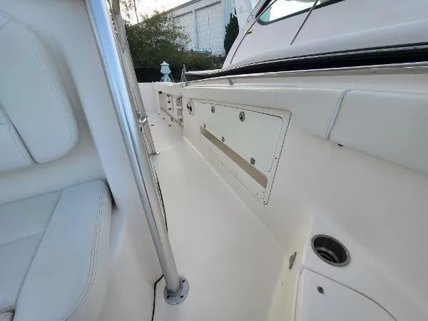 Slide: The Image of 2014 Robalo R 300 boat interior with white seating and storage compartments. - 8