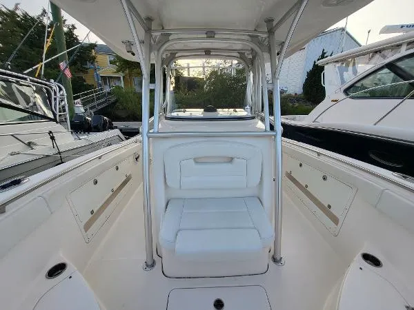 Slide: The Image of 2014 Robalo R 300 boat interior with white seating and sleek design. - 9