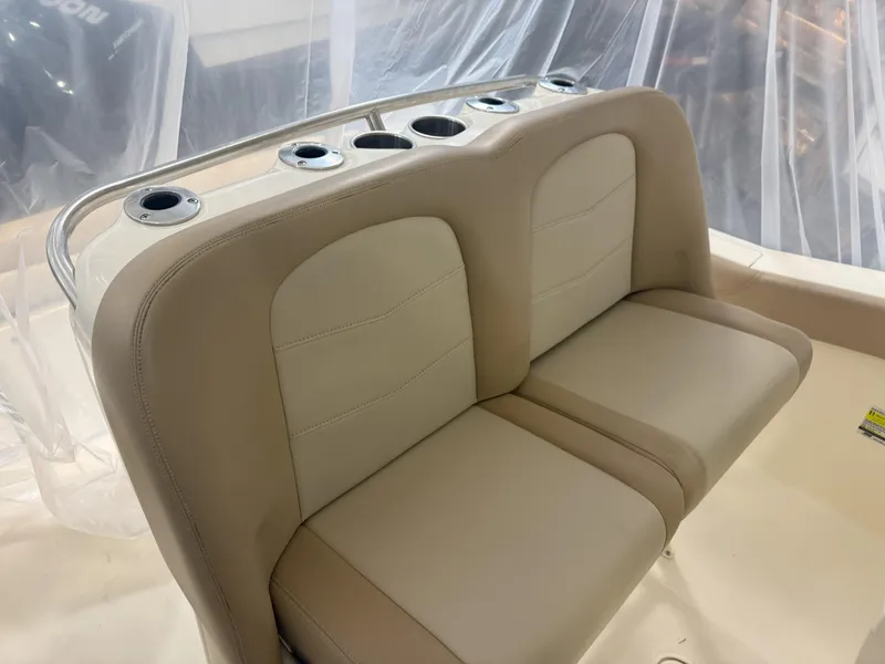Slide: The Image of 2022 Scout 255 LXF boat seating with rod holders, beige upholstery. - 10