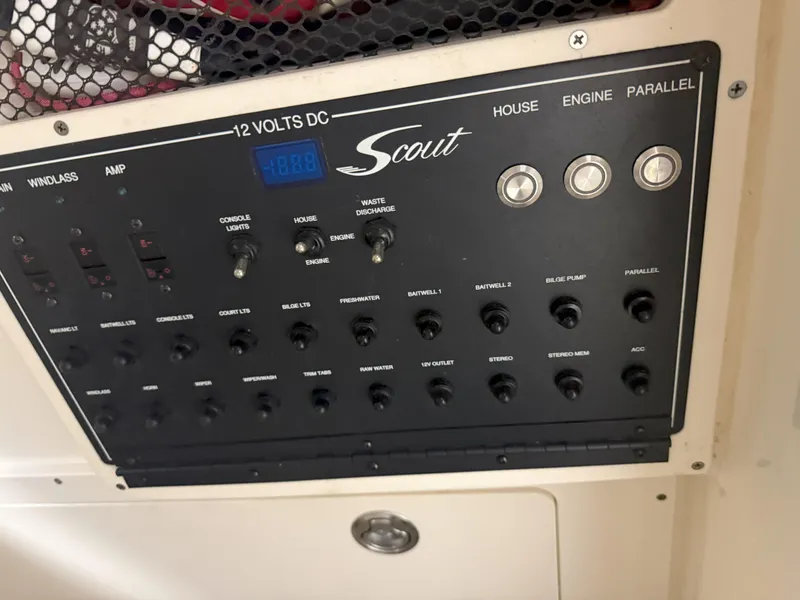 Slide: The Image of Control panel of a 2022 Scout 255 LXF boat with various switches and indicators. - 12
