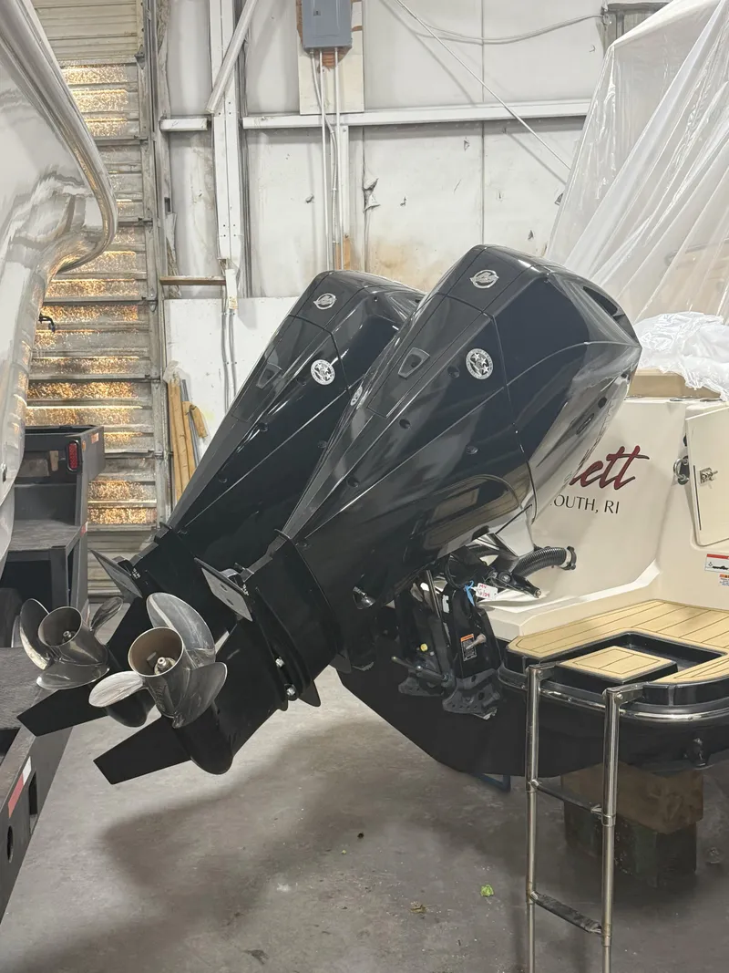 Slide: The Image of 2022 Scout 255 LXF boat with dual outboard motors in a storage facility. - 20