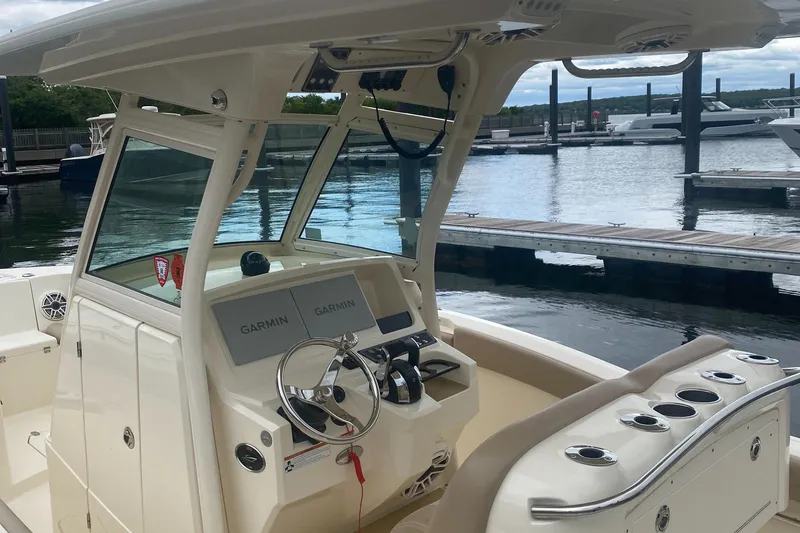 Slide: The Image of 2022 Scout 255 LXF boat interior with Garmin navigation, docked at marina. - 24