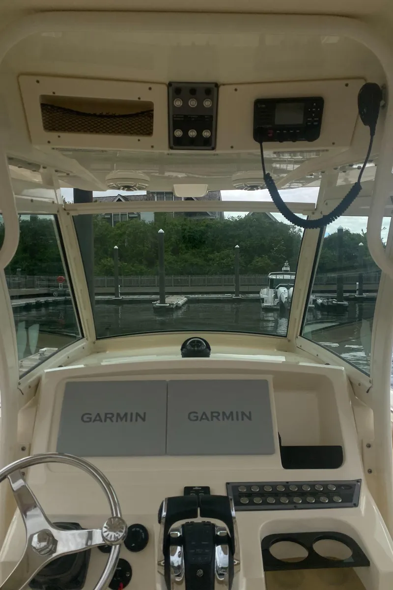 Slide: The Image of 2022 Scout 255 LXF boat dashboard with Garmin navigation system at marina. - 27