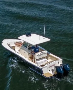 Slide: The Image of 2022 Scout 255 LXF boat cruising on open water with dual engines. - 3