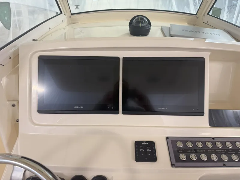 Slide: The Image of 2022 Scout 255 LXF boat dashboard with dual Garmin screens and control panel. - 8