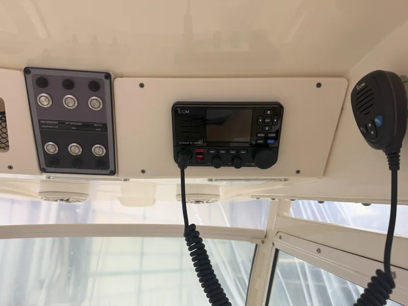 Slide: The Image of 2022 Scout 255 LXF boat dashboard with control panel and radio system. - 9