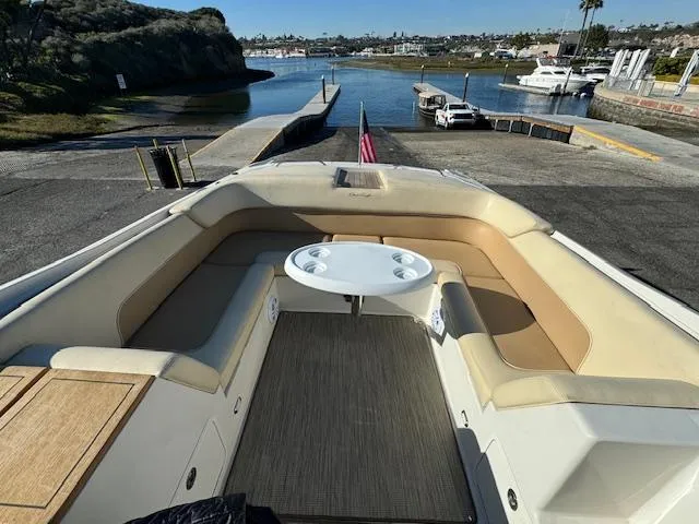 Slide: The Image of 2007 Chris-Craft Corsair 28 boat with seating area and table at dock. - 10