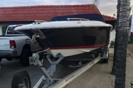 Slide: The Image of 2007 Chris-Craft Corsair 28 boat on trailer in front of house. - 21