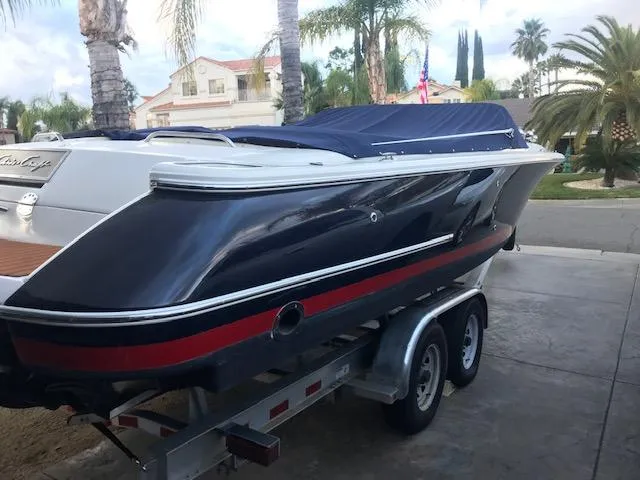 Slide: The Image of 2007 Chris-Craft Corsair 28 boat on trailer, blue with red stripe. - 22