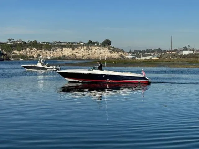 Slide: The Image of 2007 Chris-Craft Corsair 28 on calm water with coastal backdrop. - 6