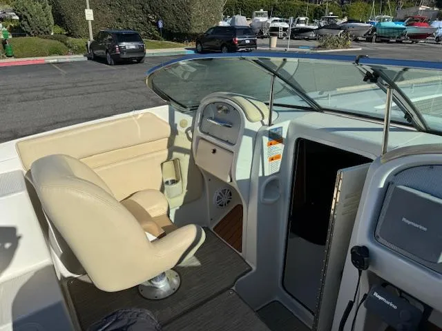 Slide: The Image of Interior of a 2007 Chris-Craft Corsair 28 boat, beige seats, helm console. - 9