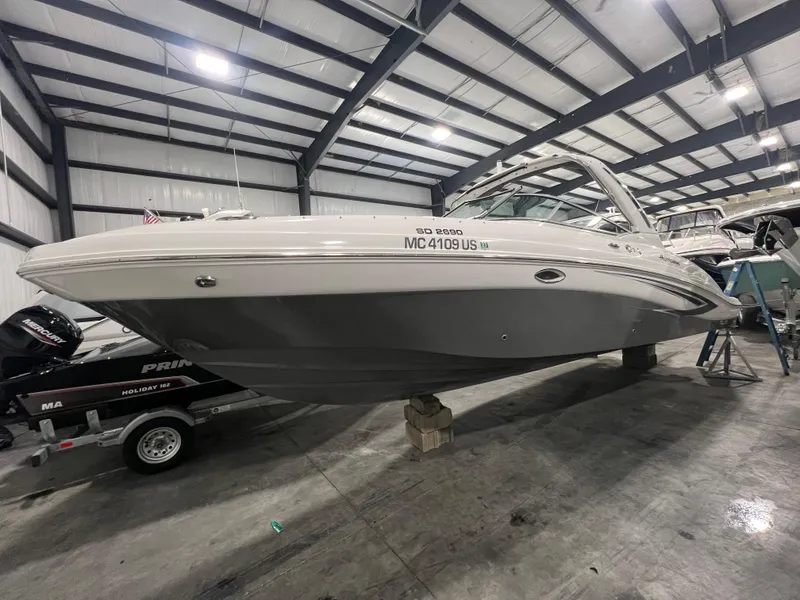 Slide: The Image of 2021 Hurricane SunDeck 2690 OB boat in indoor storage facility. - 0