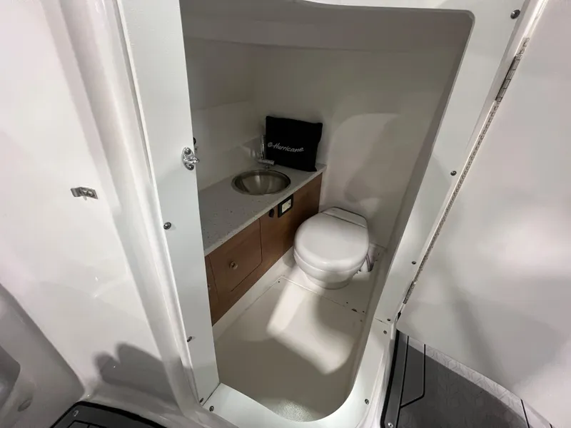 Slide: The Image of 2021 Hurricane SunDeck 2690 OB boat interior bathroom with sink and toilet. - 11