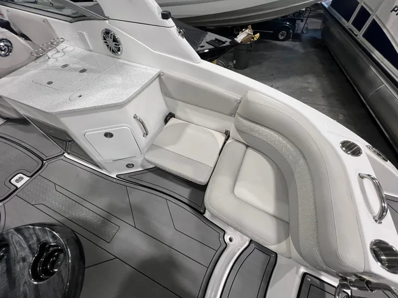 Slide: The Image of 2021 Hurricane SunDeck 2690 OB boat interior with white seating and storage area. - 5