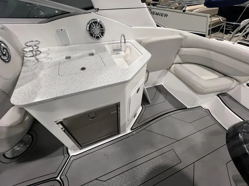 Slide: The Image of 2021 Hurricane SunDeck 2690 OB boat interior with sink and seating area. - 6