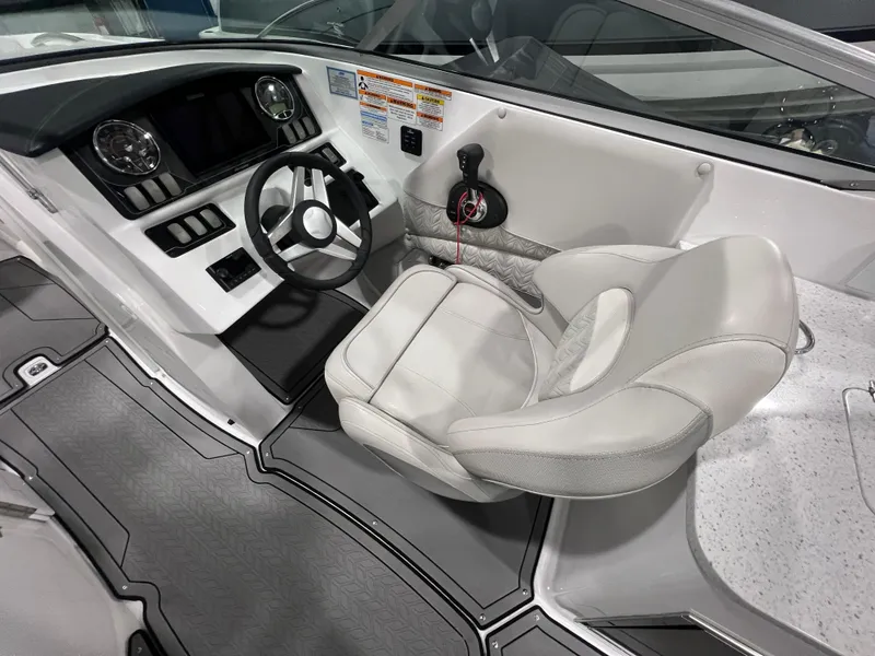 Slide: The Image of 2021 Hurricane SunDeck 2690 OB boat cockpit with steering wheel and captain's chair. - 8