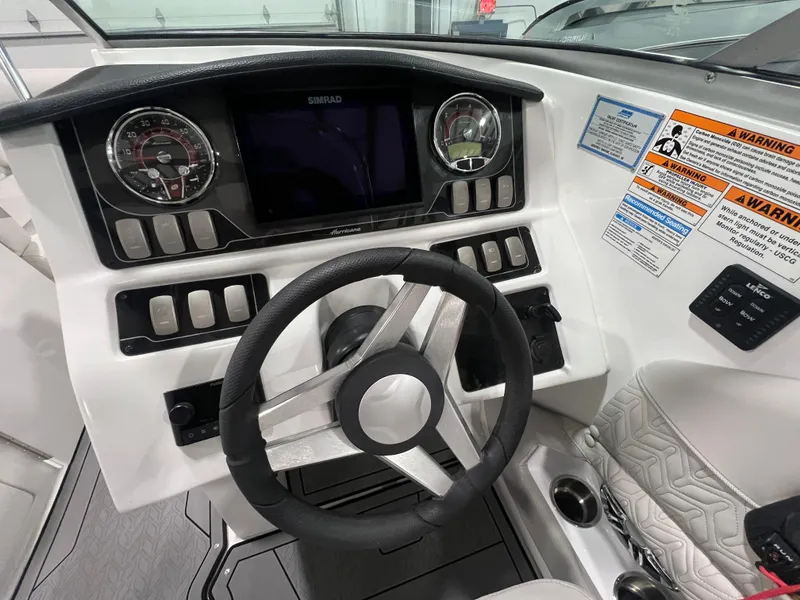Slide: The Image of 2021 Hurricane SunDeck 2690 OB boat dashboard with steering wheel and control panel. - 9