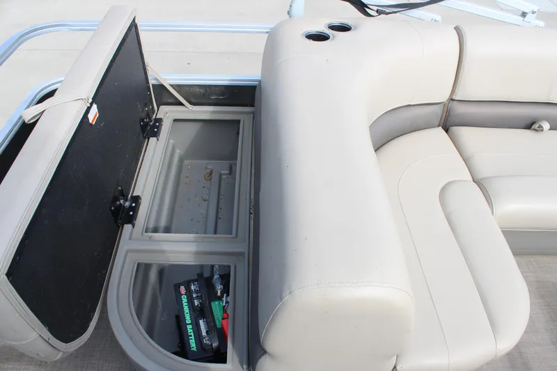 Slide: The Image of 2022 Sun Tracker Party Barge 18 DLX storage compartment with battery and seating. - 10