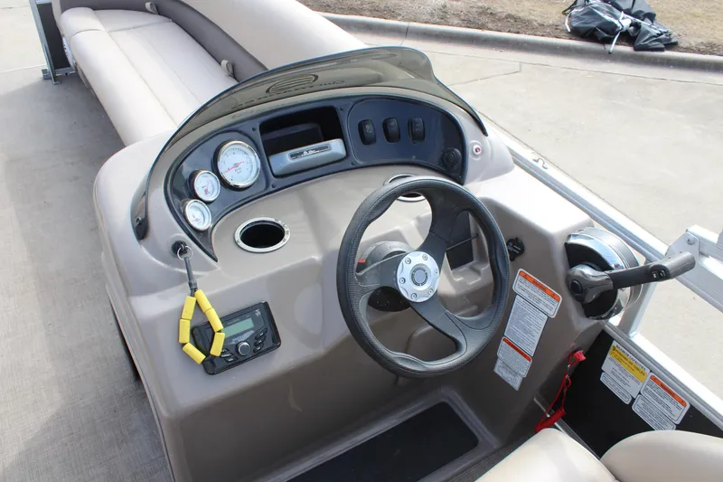 Slide: The Image of 2022 Sun Tracker Party Barge 18 DLX dashboard with steering wheel and controls. - 14