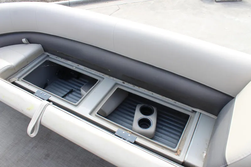 Slide: The Image of 2022 Sun Tracker Party Barge 18 DLX storage compartment with cup holders. - 18